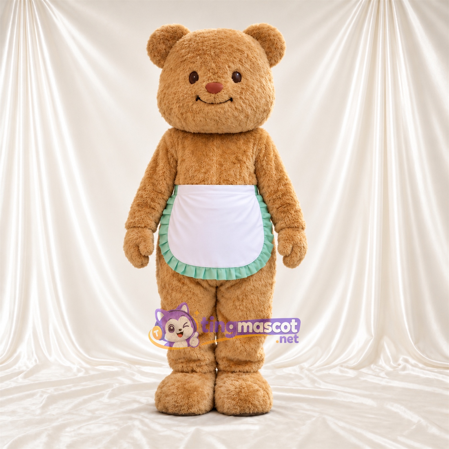 Maskottchenkostüm Bär – hellbraun – Schürze (weiß / grün); Ohren Maskottchenkostüm Bär – hellbraun – Schürze (weiß / grün); Ohren