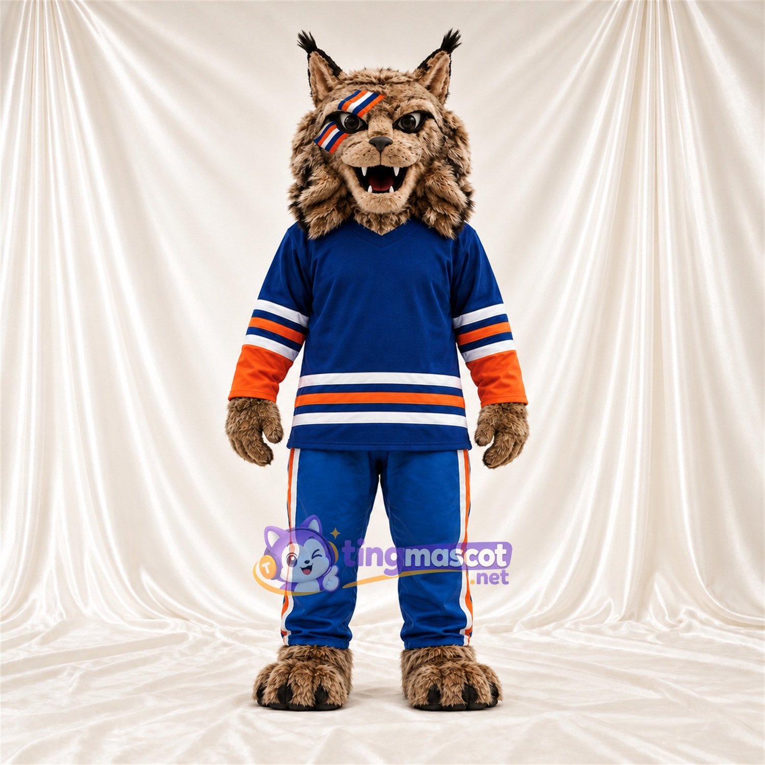 Costume de mascotte Chat sauvage – brun clair – Maillot; Pantalon (bleu) Costume de mascotte Chat sauvage – brun clair – Maillot; Pantalon (bleu)