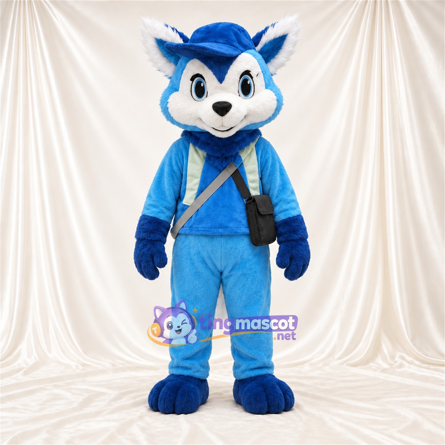 Blue and White Fox Mascot Costume - Blue Outfit, Hat and Shoulder Bag Blue and White Fox Mascot Costume - Blue Outfit, Hat and Shoulder Bag