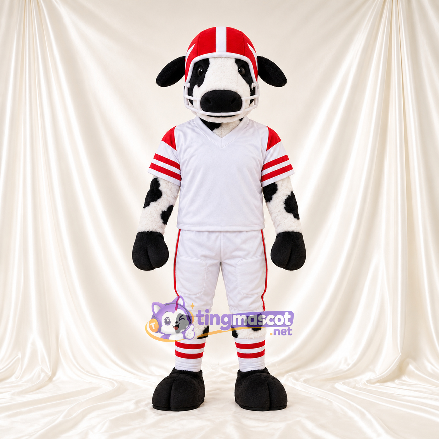Black and White Cow Mascot Costume - White Football Uniform and Red Helmet, Black Floppy Ears and Black Hooves Black and White Cow Mascot Costume - White Football Uniform and Red Helmet, Black Floppy Ears and Black Hooves