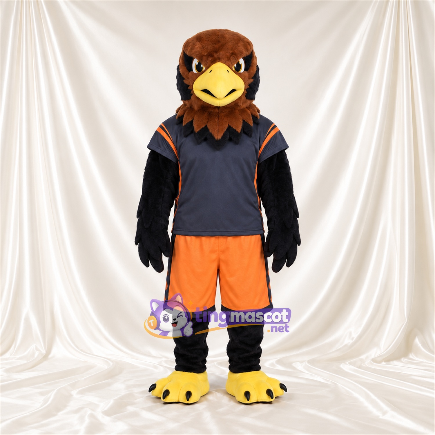 Costume de mascotte Faucon – marron – Maillot de sport (bleu marine); Short (orange) Costume de mascotte Faucon – marron – Maillot de sport (bleu marine); Short (orange)
