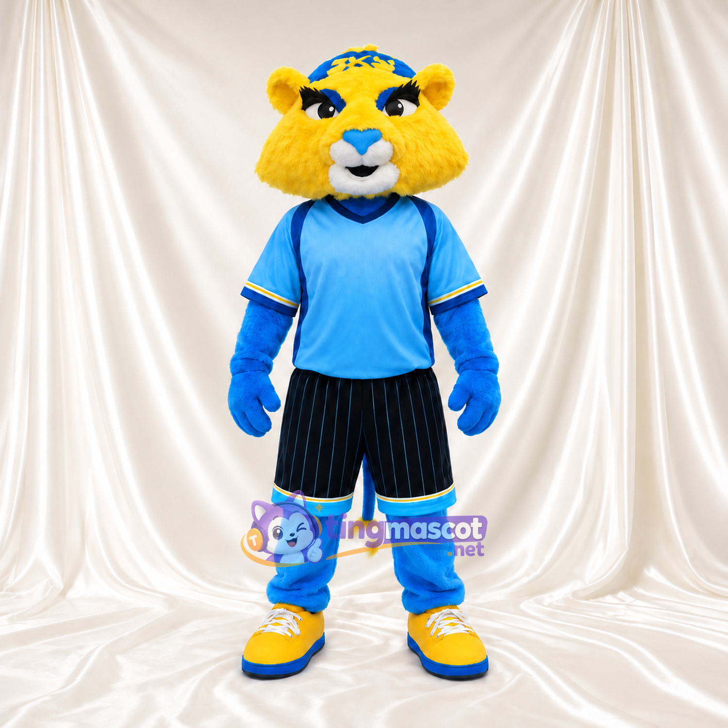 Maskottchenkostüm Katze – gelb / blau – Sportshirt (blau); Shorts (schwarz) Maskottchenkostüm Katze – gelb / blau – Sportshirt (blau); Shorts (schwarz)