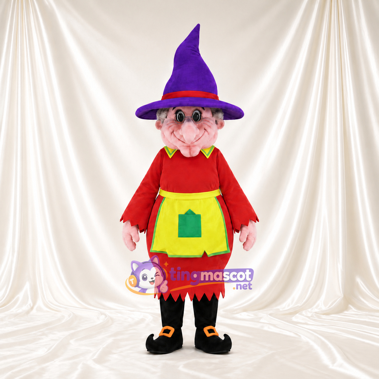 Maskottchenkostüm Hexe – wie abgebildet – Hut (violett); Kleid (rot); Schürze (gelb)