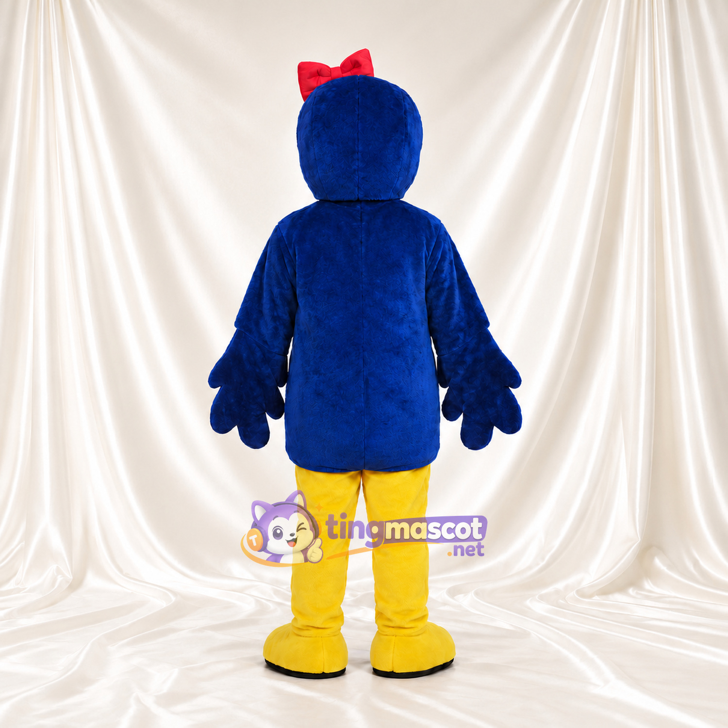 Costume de mascotte Oiseau – bleu / jaune – Nœud sur la tête (rouge) Costume de mascotte Oiseau – bleu / jaune – Nœud sur la tête (rouge)